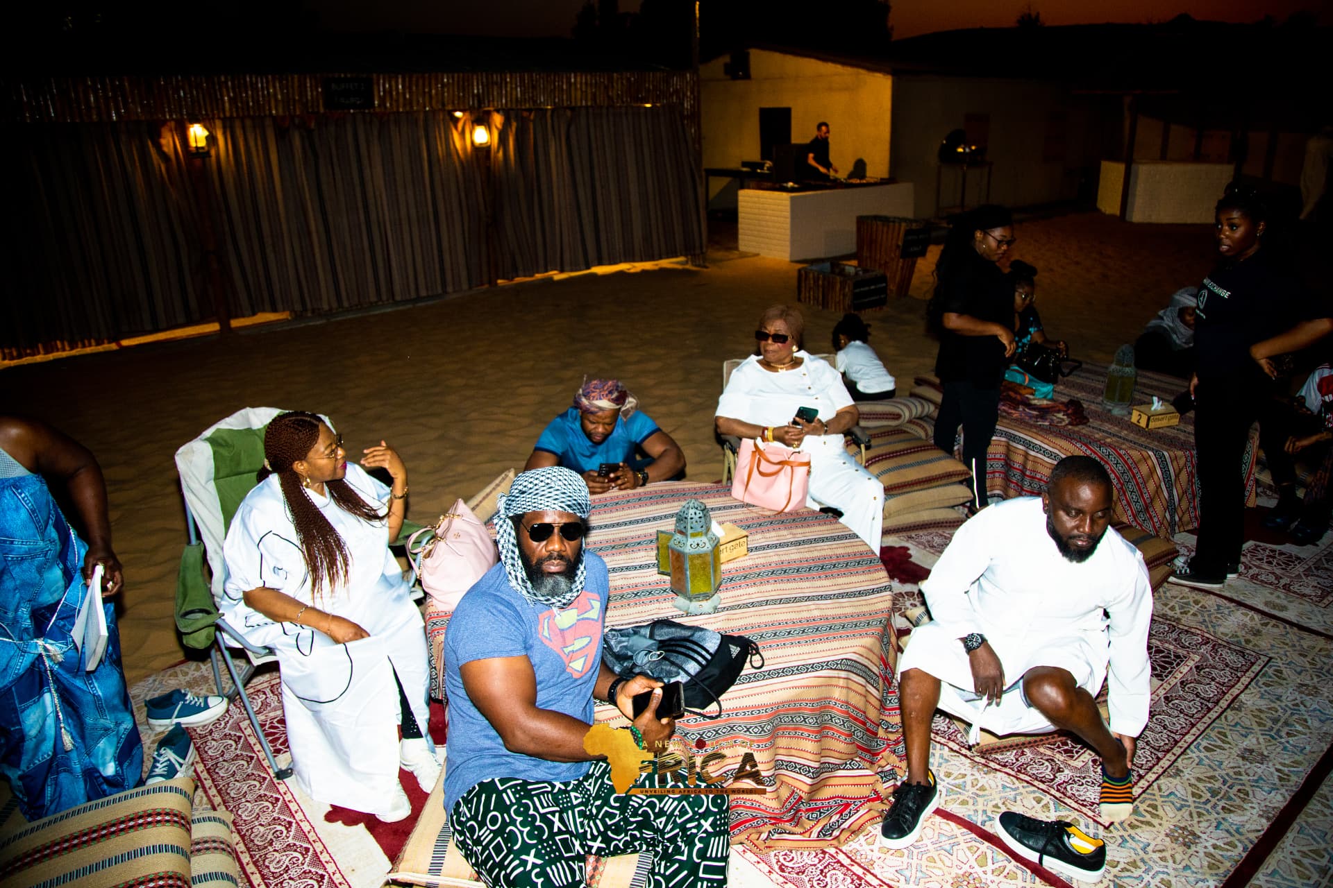 Guests relaxing on traditional majlis seating at the ANTOA desert evening in Dubai