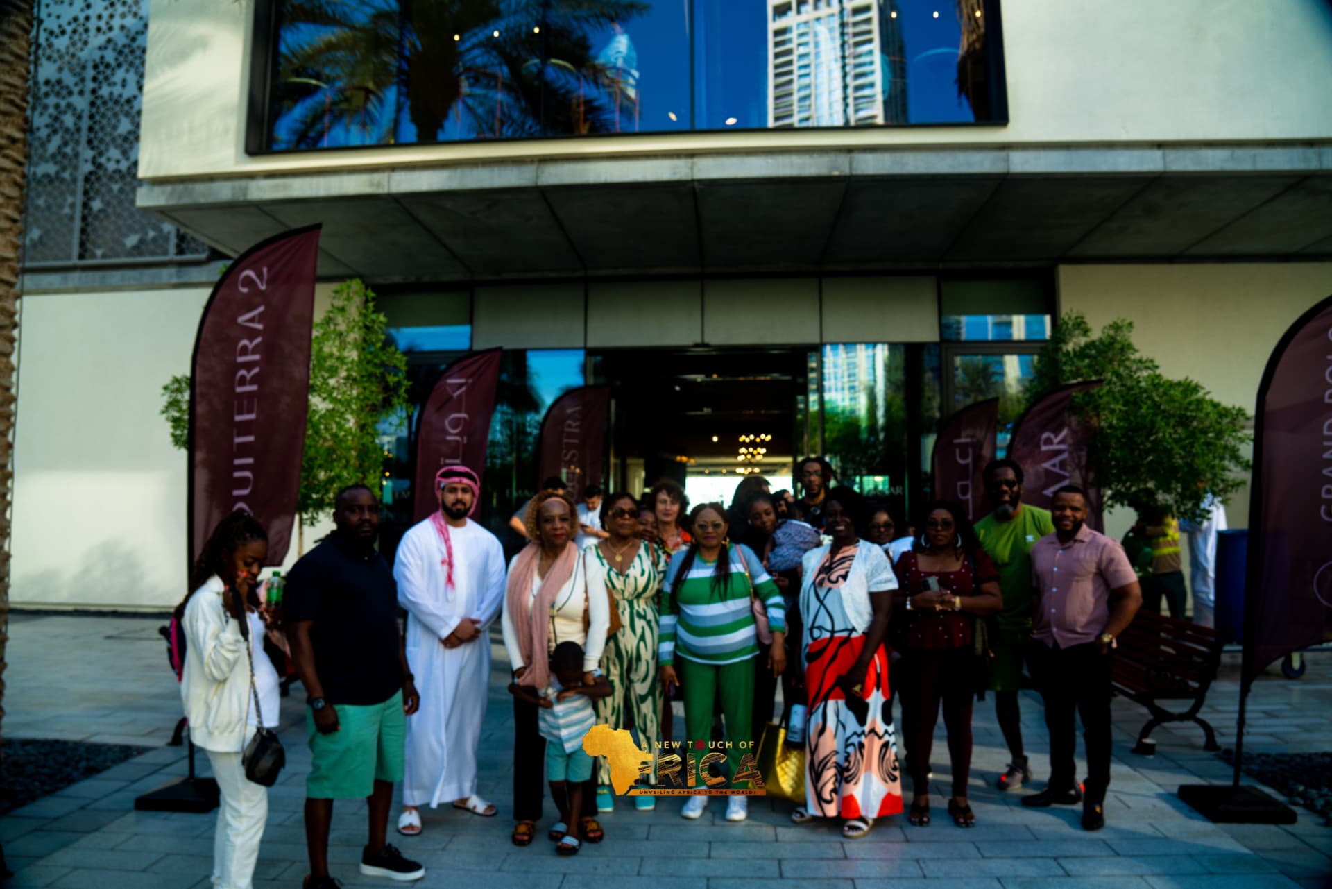 ANTOA guests posing beneath the Emaar banners in Dubai Creek Harbour